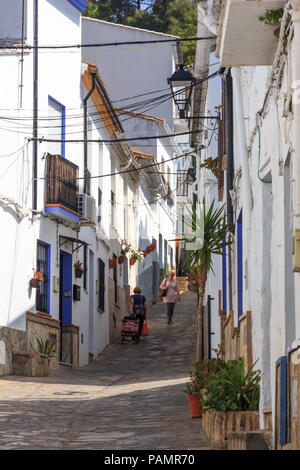 Ubrique, Spain - 25th June 2018: Woman walking down steep narrow street. Many of the streets are unsuitable for vehicles. Stock Photo