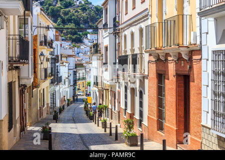 Ubrique, Spain - 25th June 2018: 2 women walking down a street. Streets in the old town are very narrow. Stock Photo