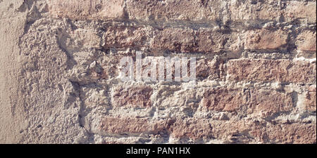 Old grungy red and white brick wall with damaged plaster banner background texture. Stock Photo