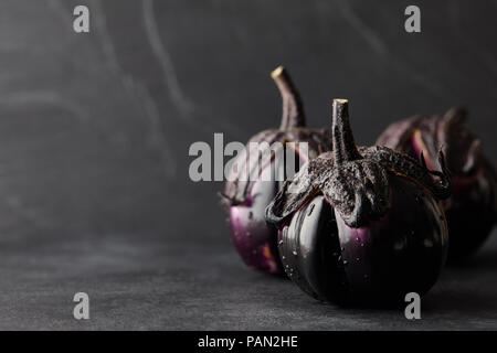 Fresh eggplants with water drops closeup on black background Stock Photo