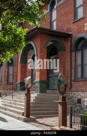 Red brick building with black iron fence. Historical Mining and Mineral Museum with library, photos and more for viewing.Located in downtown Bisbee AZ. Stock Photo