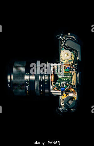 Disassembled vintage SLR camera showing electronics for repair Stock Photo