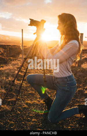 Iceland, female fotographer at sunset Stock Photo