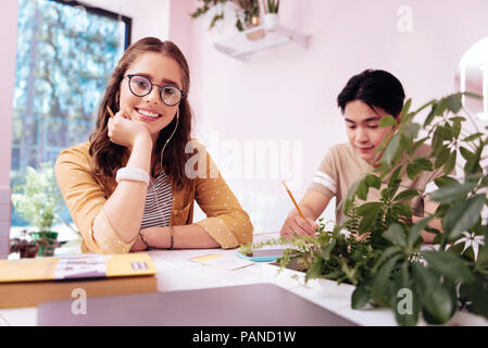 Stylish modern student spending her break in little coffee room Stock Photo