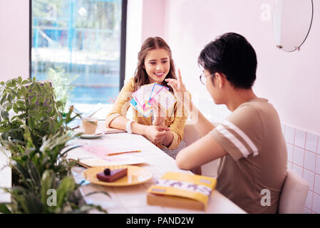 Two smart students using interactive cards studying together Stock Photo