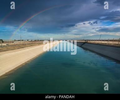 Agricultural irrigation channel and rainbow Stock Photo