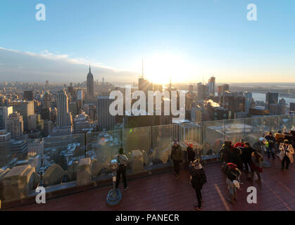 Tourists enjoy a panoramic view of Manhattan from viewing platform at the top of the Rockefeller Centre (Top of the Rocks) , New York City, USA , Dece Stock Photo