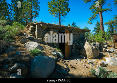 Old stone and wood structure in the forest along Highway 108, California Stock Photo