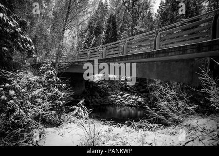Snow covered Tuolumne River canyon in Black and White  - below a bridge on evergreen Road - Highway 120, Yosemite National Park Stock Photo