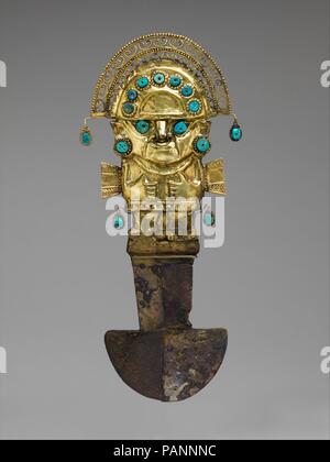 Ceremonial Knife (Tumi). Culture: Lambayeque (Sicán). Dimensions: H. 14 1/4 × W. 6 1/4 × D. 1 5/8 in. (36.2 × 15.9 × 4.1 cm). Date: A.D. 900-1100.  Around A.D. 1000, high-status tombs were constructed at Batán Grande, a site now called the Sicán Archaeological Precinct, where a single burial could include as many as five masks: one attached to the head and the others stacked at the feet. The shape of the eyes is characteristic of the Sicán deity, also shown atop the ceremonial knife (tumi).     Alrededor del año 1000 d. C. se construyeron tumbas para personajes de alto rango en Batán Grande, u Stock Photo