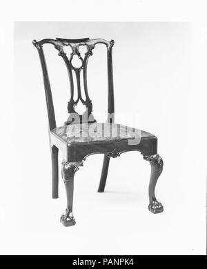 Side chair. Culture: American. Dimensions: 39 x 21 1/2 x 21 1/2 in. (99.1 x 54.6 x 54.6 cm). Date: 1760-90.  This is an example of the trefoil-pierced-splat chair, which was especially popular in Philadelphia. Except for the scroll-like central part of the crest rail, the design of the entire back was taken line for line from plate 10 of the first edition of Thomas Chippendale's 'Gentleman and Cabinet-Maker's Director' (1754). Museum: Metropolitan Museum of Art, New York, USA. Stock Photo