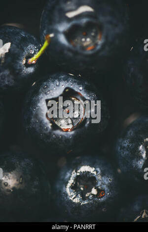 Flat-lay of wet dark forest blueberries, top view, vertical composition Stock Photo