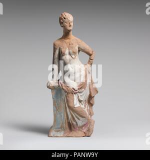 Terracotta statuette of a woman leaning on a pillar. Culture: Greek, South Italian, Tarentine. Dimensions: H. 11 7/16 in. (29.1 cm). Date: 2nd century B.C..  Standing, legs crossed, upper part of figure undraped, leaning right hand on pedestal. Museum: Metropolitan Museum of Art, New York, USA. Stock Photo