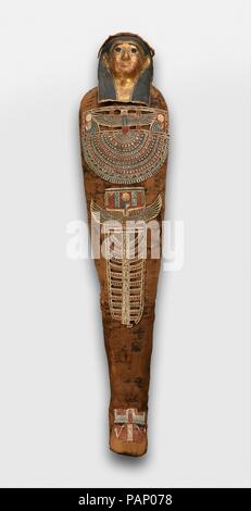 Mummy of Nesmin with plant wreath, mummy mask and other cartonnage elements. Dimensions: L.174 cm (68 1/2 in.); W. 37 cm (14 9/16 in.); H. 27 cm (10 5/8 in.). Date: 200-30 B.C..  Inside this mummy is the body of Nesmin, whose name means 'The One Who Belongs to (the god) Min.' He was a priest for Min in Akhmim, and from the inscription on his coffin (see 86.1.50a, b) we know that his father Djedhor was a priest as well, and that his mother Tadiaset was a musician for Min. CT scans have shown that Nesmin suffered from arthritis and died as a middle-aged man. They also revealed that thirty-one am Stock Photo