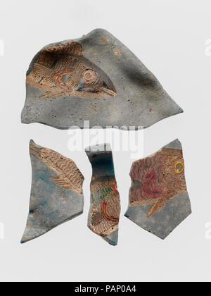 Glass fragments of bowl decorated with mosaic fish. Culture: Roman. Dimensions: Overall (a): 1 3/4 x 1 3/16 in. (4.4 x 3 cm)  Overall (b): 2 1/4 x 2 7/8 in. (5.7 x 7.3 cm)  Overall (c): 1 5/8 x 1 5/8 in. (4.1 x 4.1 cm)  Overall (d): 1 7/8 x 9/16 in. (4.8 x 1.4 cm). Date: 1st-3rd century A.D..  The fragments depict life-like fish swimming in a river, lake, or pool, indicated by the blue glass background. It is uncertain whether they belong to a plate or a panel since they are now warped out of shape. Museum: Metropolitan Museum of Art, New York, USA. Stock Photo