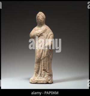 Terracotta statuette of a woman standing. Culture: Greek. Dimensions: H. w/ stand: 6 in. (15.2 cm). Date: 4th-3rd century B.C..  Standing, draped statue of a woman. Museum: Metropolitan Museum of Art, New York, USA. Stock Photo