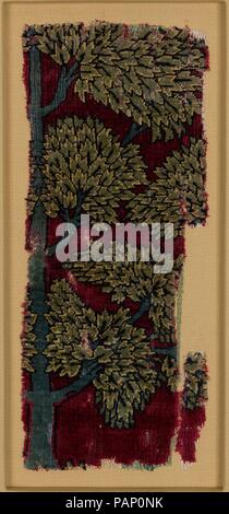 Pashmina Carpet Fragment. Dimensions: Textile: L. 13 1/2 in. (34.3 cm)   W.  5 1/4 in. (13.3 cm)  Mount: L. 17 7/8 in. (45.4 cm)   W. 10 1/8 in. (25.7 cm)  D. 7/8 in. (2.2 cm). Date: first half 17th century.  This carpet fragment and the others in the group come from a well-known carpet of which the main part is in the Frick Collection, New York. The rich red of the ground would have been achieved with the expensive insect dye called lac, probably combined with the madder plant. Museum: Metropolitan Museum of Art, New York, USA. Stock Photo