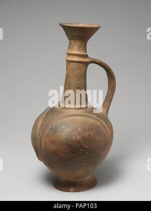 Terracotta jug. Culture: Cypriot. Dimensions: H. 8 15/16 in. (22.7 cm). Date: ca. 1600-1450 B.C..  Narrow-necked jug with funnel-shaped mouth, handle and curved bands in relief. Museum: Metropolitan Museum of Art, New York, USA. Stock Photo