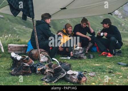 Norway, Lofoten, Moskenesoy, Young men camping at Horseid Beach Stock Photo