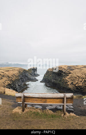 Iceland, empty bench with view to coast Stock Photo