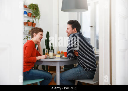 Couple sitting in kichen, talking, having breakfast Stock Photo
