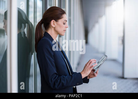 Businesswoman using tablet outdoors Stock Photo