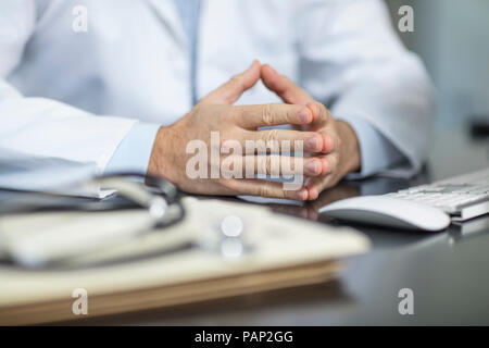 Files and stethoscope on desk in medical practice and doctor's hands Stock Photo
