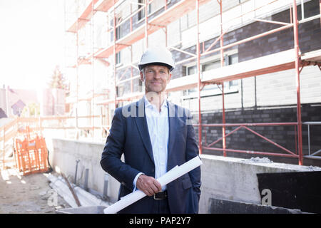 Portrait of confident architect wearing hard hat on construction site Stock Photo