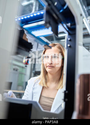 Female technician checking 3D printer Stock Photo