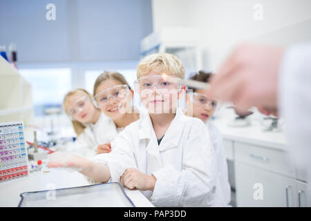 Portrait of smiling pupils in science class Stock Photo