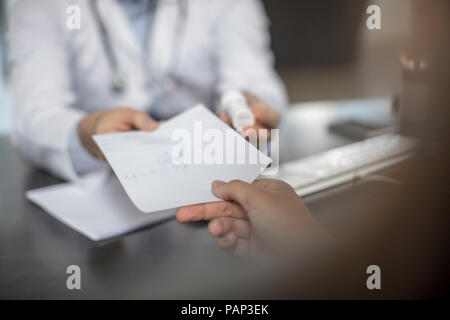 Doctor giving patient a note Stock Photo