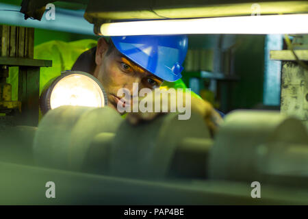 Engineer in industrial plant inspecting machines Stock Photo
