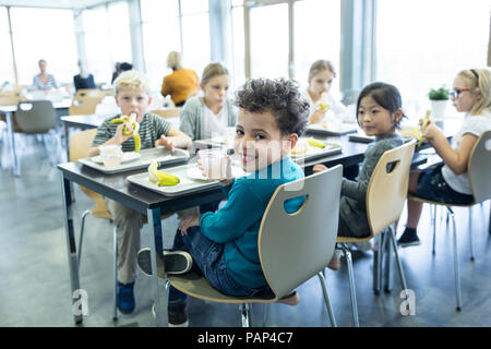Pupils having lunch in school canteen Stock Photo