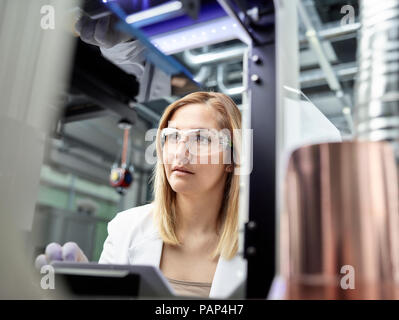 Female technician checking 3D printer Stock Photo