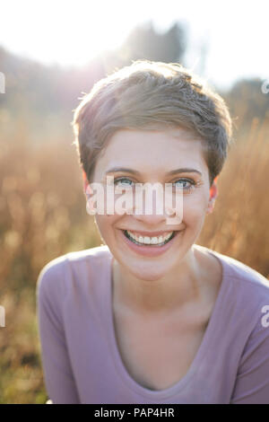 Portrait of laughing woman in nature Stock Photo