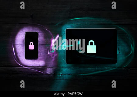 Locks on smartphone and digital tablet, data encryption Stock Photo