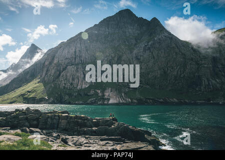 Norway, Lofoten, Moskenesoy, Young men camping at Horseid Beach Stock Photo