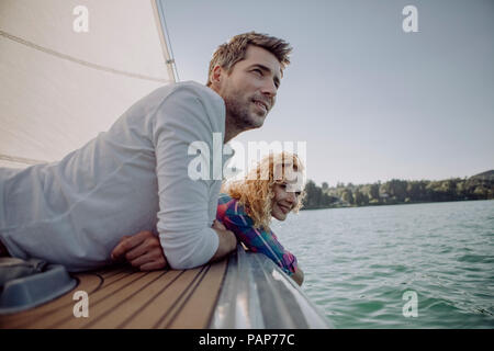 Smiling couple relaxing on a sailing boat Stock Photo