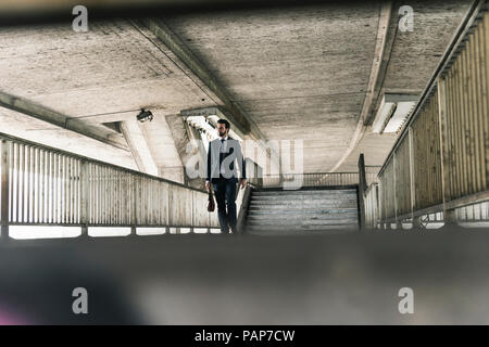Businessman walking at underpass Stock Photo