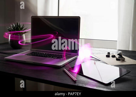 Modern office with laptop and digital tablet on desk Stock Photo