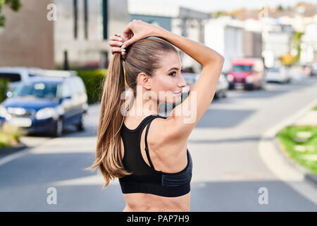 Attractive sportive young woman on a street in the city Stock Photo