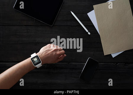Man wearing smartwatch in office Stock Photo