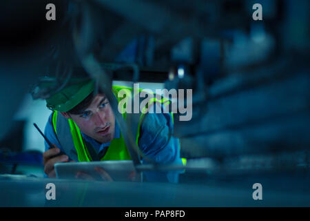 Engineer in industrial plant inspecting machines Stock Photo