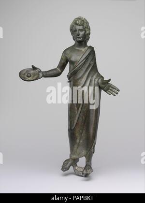 Bronze statuette of a priest. Culture: Etruscan. Dimensions: H. 11 5/8 in. (29.5 cm). Date: 3rd-2nd century B.C..  This large statuette portrays a man, perhaps a votary or a priest, pouring an offering to the gods from a patera (libation bowl) held in his right hand.  The gesture is typical of human and divine beings who are making sacrifice. Museum: Metropolitan Museum of Art, New York, USA. Stock Photo