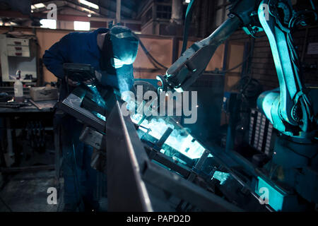 Welder welding metal with robot Stock Photo