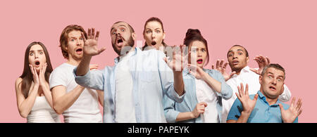 Group of frightened people, woman and man stressful keeping hands on head, terrified in panic, shouting Stock Photo
