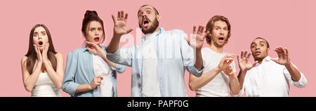 Group of frightened people, woman and man stressful keeping hands on head, terrified in panic, shouting Stock Photo