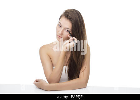 beautiful girl applying eyeliner Stock Photo
