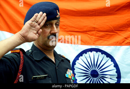 Army Soldier Saluting the National flag Stock Photo