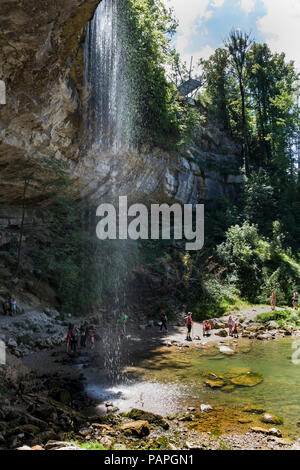 Visitors Enjoying the 35m Saut Girard Waterfall on a Hot Summer Day, Cascades du Herrison, Jura, France. Stock Photo